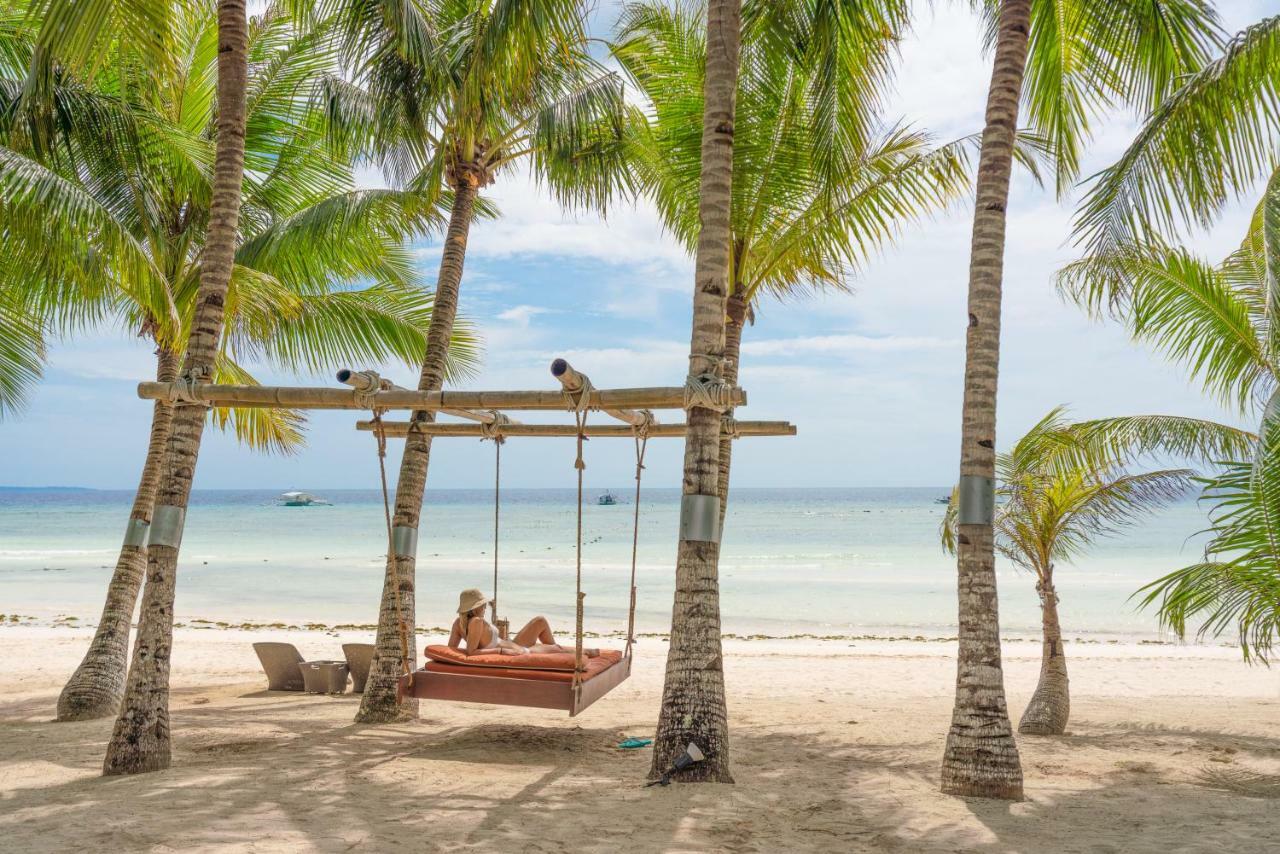 Oceanica Resort Panglao, Bohol Bagian luar foto A swing at the beach